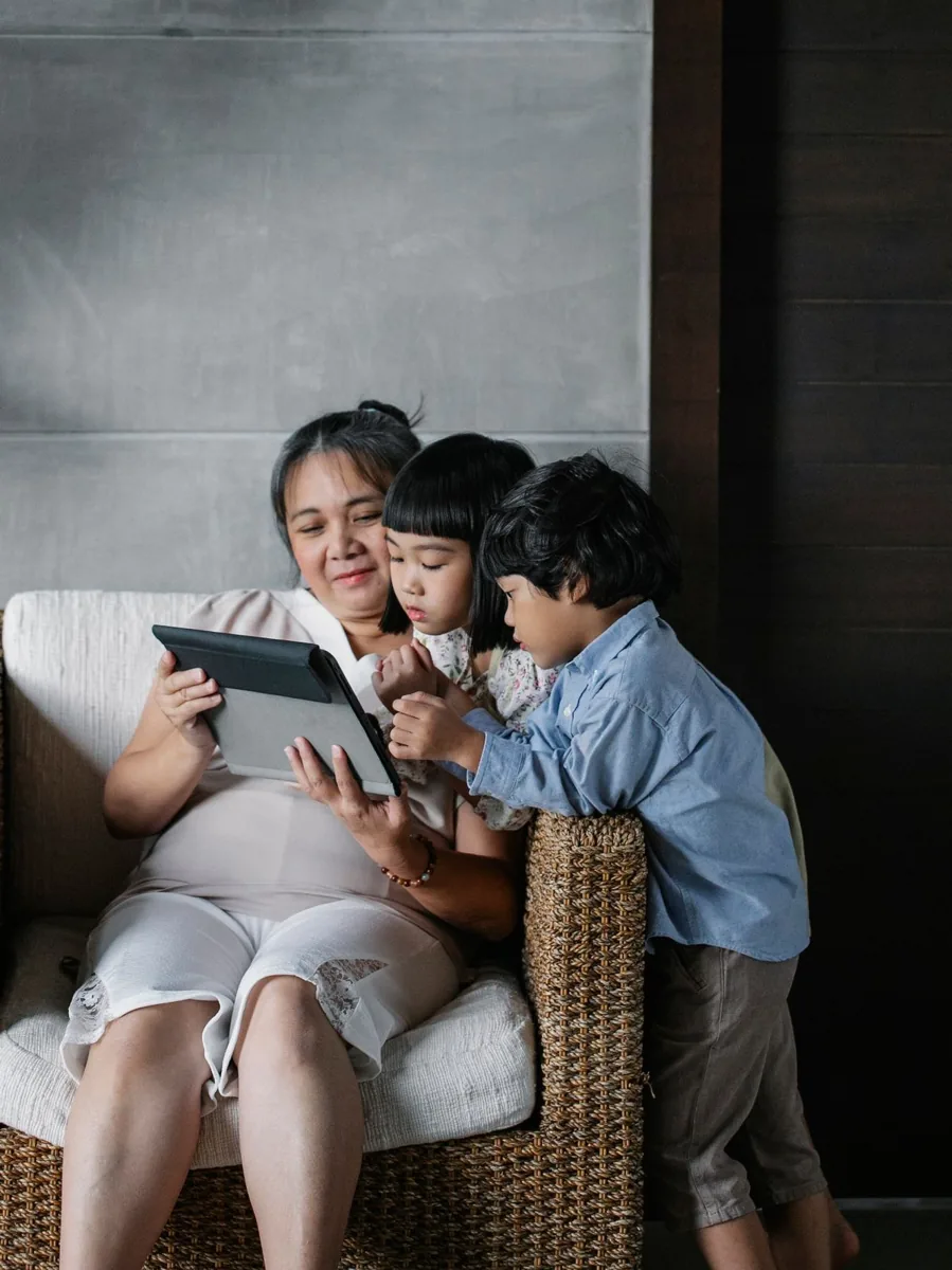 Grandmother and children looking at a tablet together