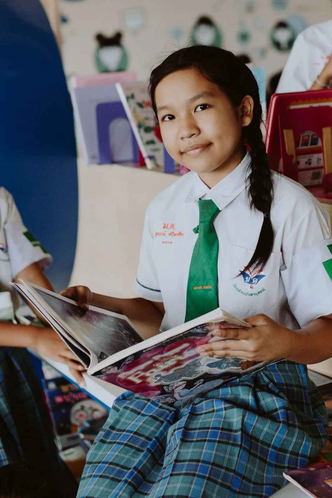 Student reading a book in a school library
