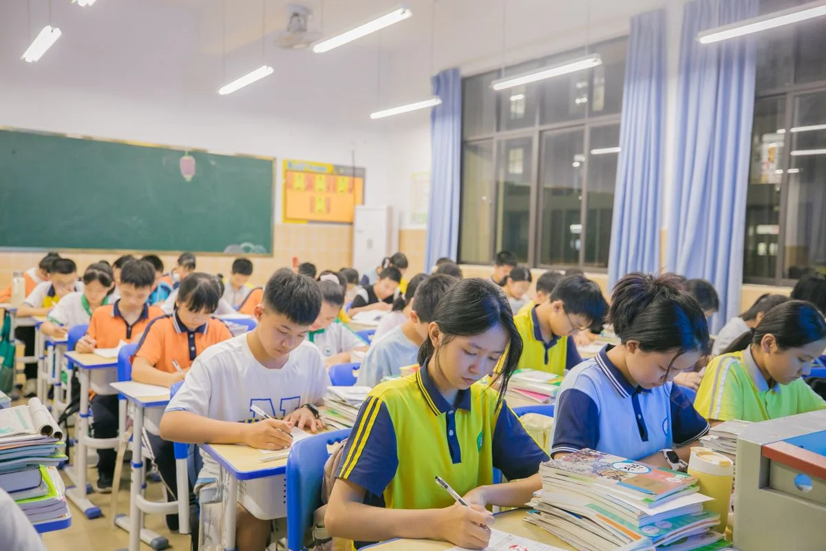 Children writing at desks in a classroom