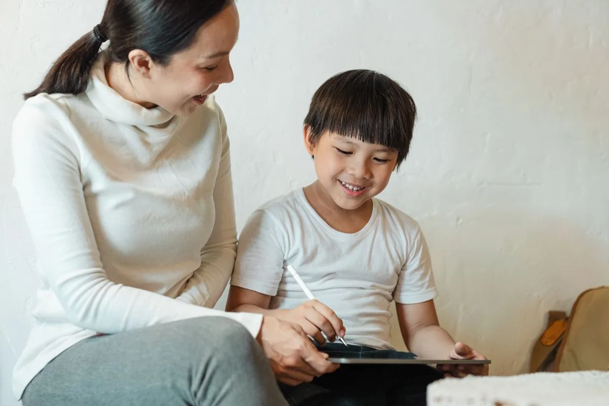 Mother and child sharing a tablet at home